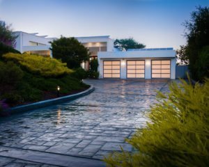A stone paved driveway leads up to an über-modern white house in Los Altos Hills.