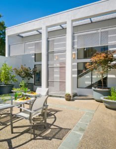 The rear of a modern Los Altos Hills home offers room to dine and relax.