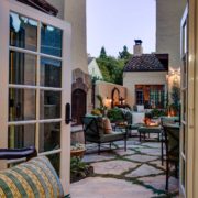 A Mediterranean-inspired patio in downtown Palo Alto features a fireplace, seating, and a fountain.