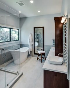 A spacious primary bathroom in Mountain View has a glass-enclosed shower and soaking tub.