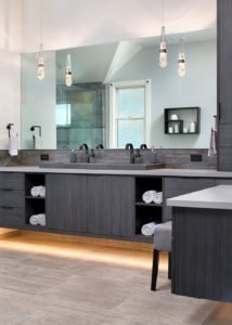 A spacious, modern, monochromatic bathroom in Willow Glen features an illuminated floating vanity.