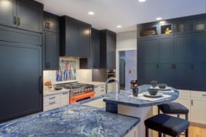 A Palo Alto kitchen using complementary colors, with blue cabinetry and a bright orange stove.