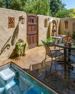 outdoor seating with wooden door and pool