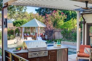 View of outdoor seating with chrome outdoor grill