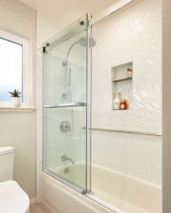 white bathroom and shower with shower shelves