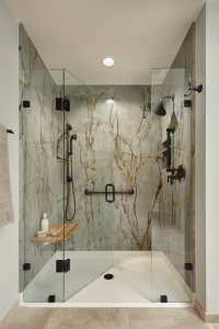 Aging in place is stylish in this Los Gatos primary bathroom, with a curbless shower and slab walls.