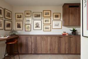 An awkwardly shaped office has been transformed into a storage space for pet supplies, and an artful gallery.