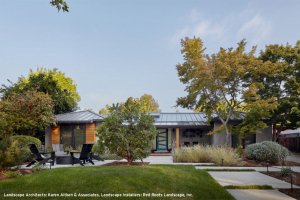 A modern home in San Jose features large concrete pavers and a sleek firepit area.
